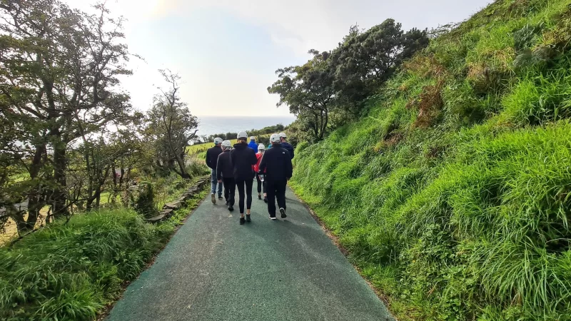Tour group walking down the footpath towards the entrance of The Gobbins cliff path entrance