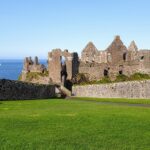 Castle perched precariously on the edge of the waters edge in Northern Ireland