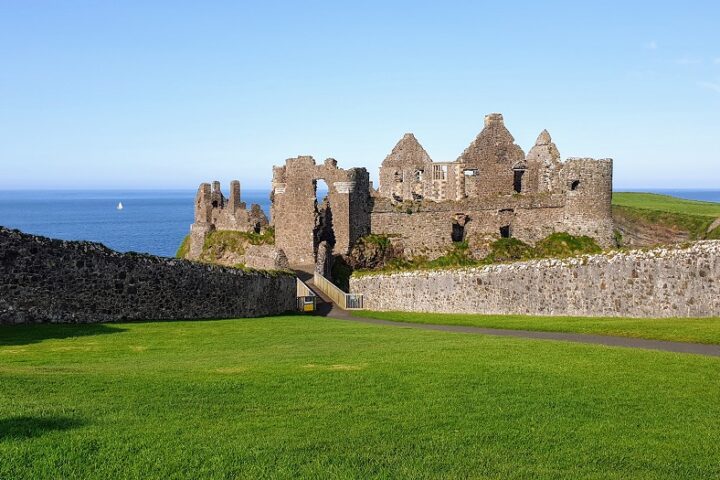 Castle perched precariously on the edge of the waters edge in Northern Ireland