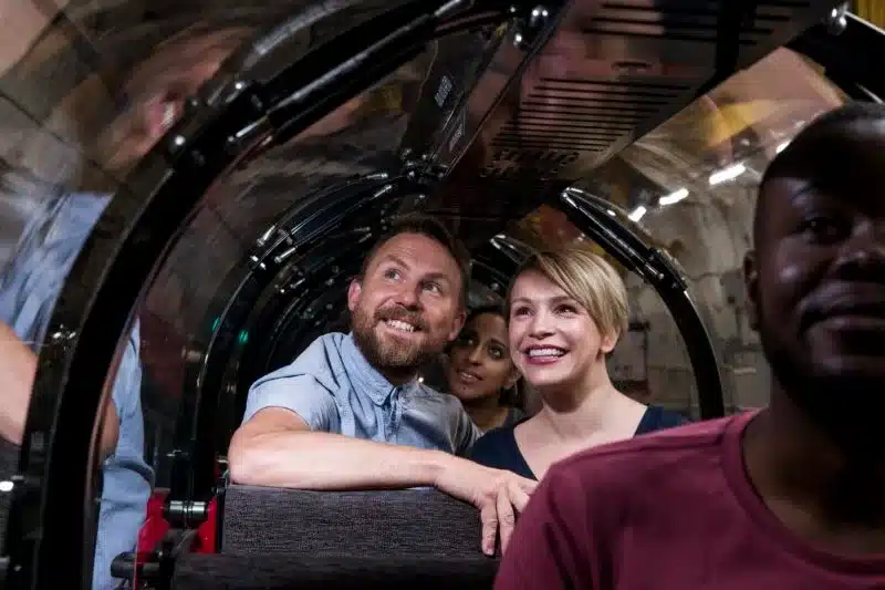 Customers onboard the Mail Rail train at the Postal Museum