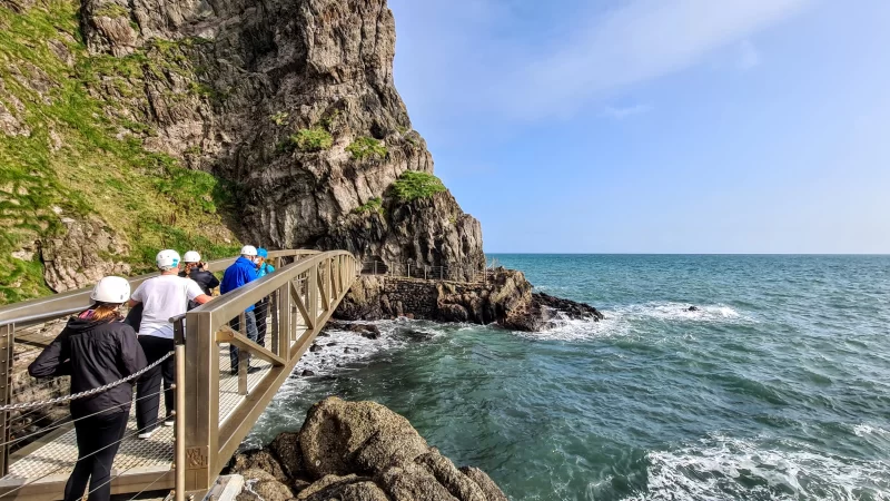 People crossing the first bridge at The Gobbins cliff path in Northern Ireland