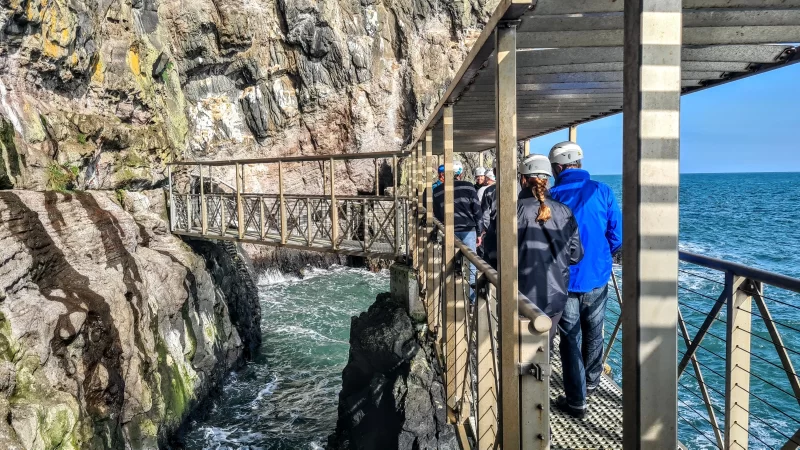 People crossing the bridge at The Gobbins cliff path which is where The Aquarium can be seen.