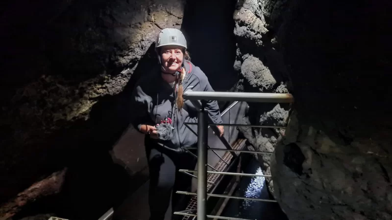 Roma ascending the stairs towards the end of The Tunnel at The Gobbins in Northern Ireland