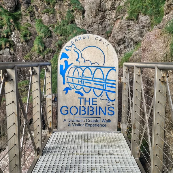 Sign from The Gobbins cliff path showing the name Sandy Cave