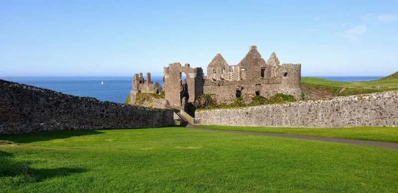 Castle perched precariously on the edge of the waters edge in Northern Ireland