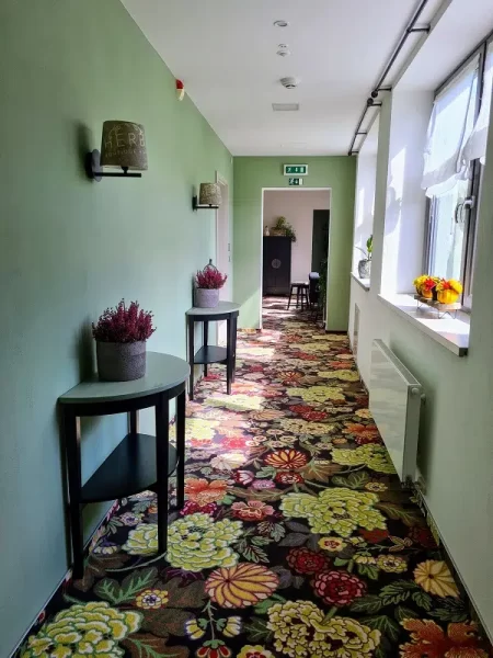 Hallway with floral decorations and carpets 