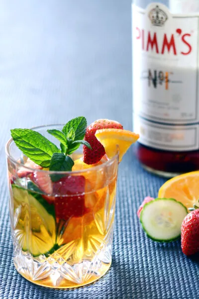 Pimms Cup with bottle of Pimms in background