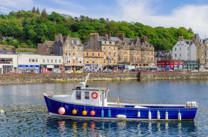 Boat floating in the harbour in Oban, Scotland. Just one of many great places to add to your list of day trips from Glasgow