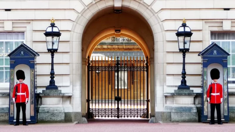 View of Buckingham Palace and the royal guards standing at their posts in front of this iconic London landmark 