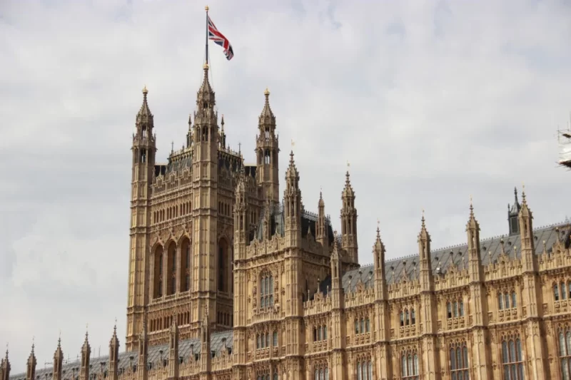 Image of the top of the Houses of Parliament/Palace of Westminster with Union Jack flag visible