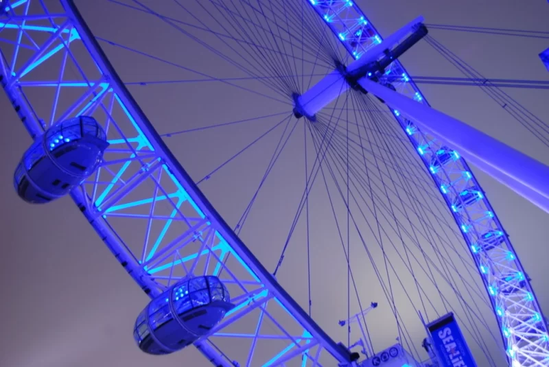 View of the the London Eye lit up in blue light 
