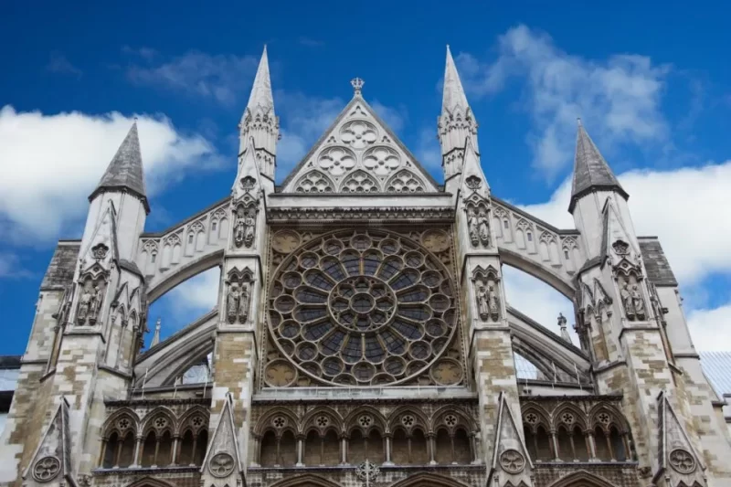 View of Westminster Abbey captured from directly in front it. Dark blue skies in the background,