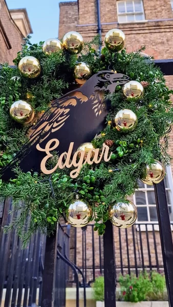 Christmas wreath with metal image of raven in centre