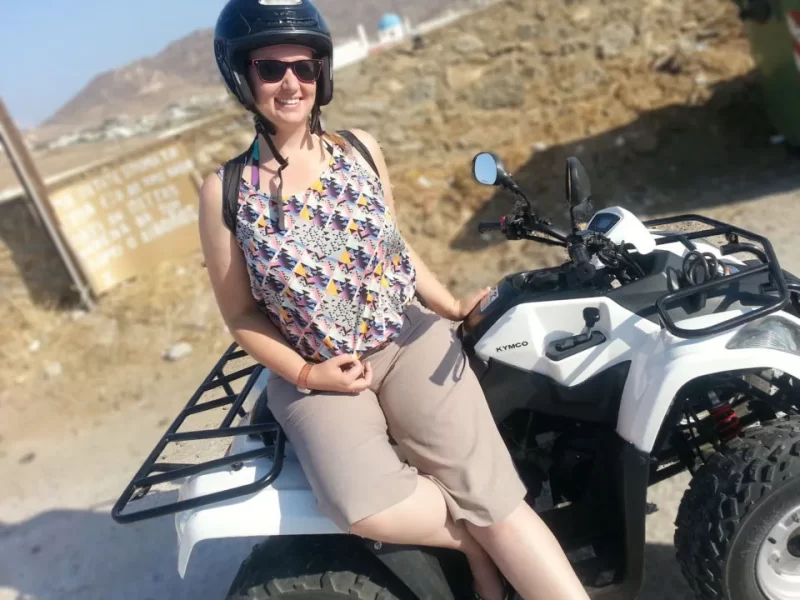 Roma leaning against a quad bike in Greece