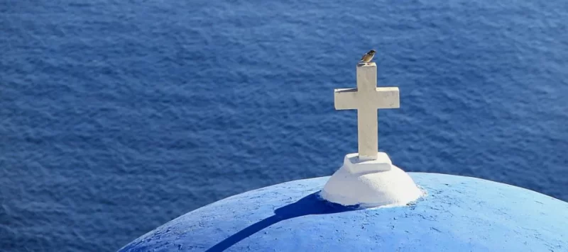 White cross on a blue dome church in Santorini