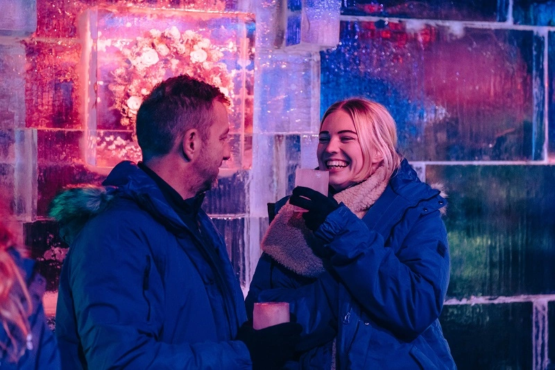 Two people wearing warm jackets at Bar Ice at Winter Wonderland