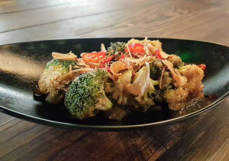 Close up of grilled broccoli dish at Yuu Kitchen