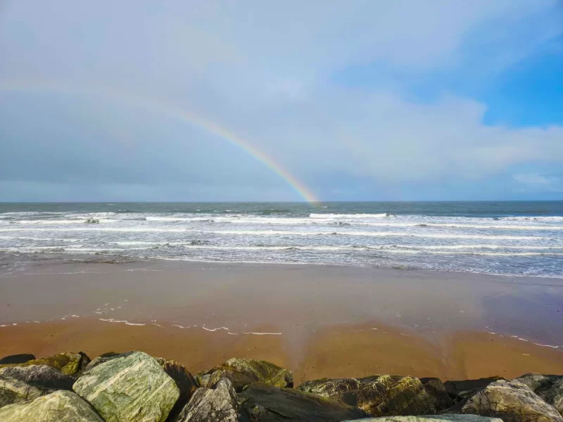 A rainbow over the Whitby Beach. Just one of the many views you'll experience when walking the The Cleveland Way in the North York Moors
