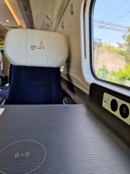 First class seat aboard Avanti West Coast trains with wireless charger icon on table