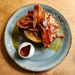 Pancake stack with streaky pancake on table at Lutt and Turner in Malton