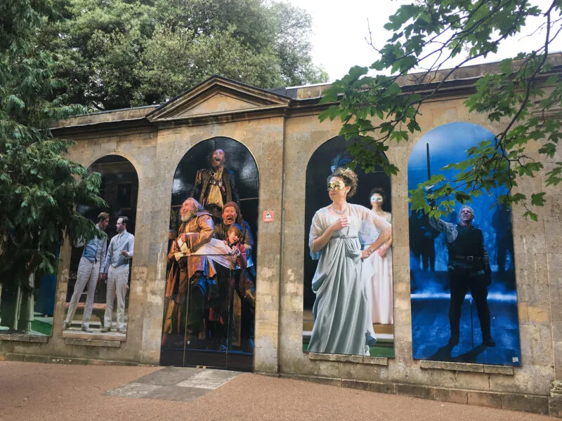 Side of stone building with art work.