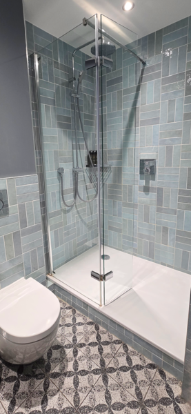 Ensuite featuring blue and grey station tiles, walk-in shower at a premium bedroom at Hotel Indigo Coventry