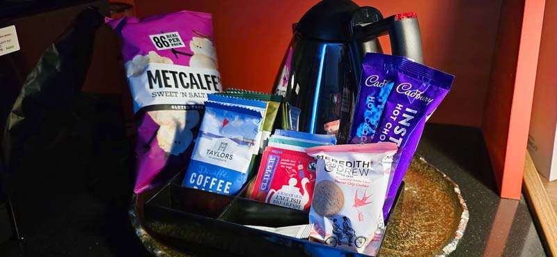 Hotel Indigo Coventry tea tray and snacks of popcorn, hot chocolate, tea, and coffee